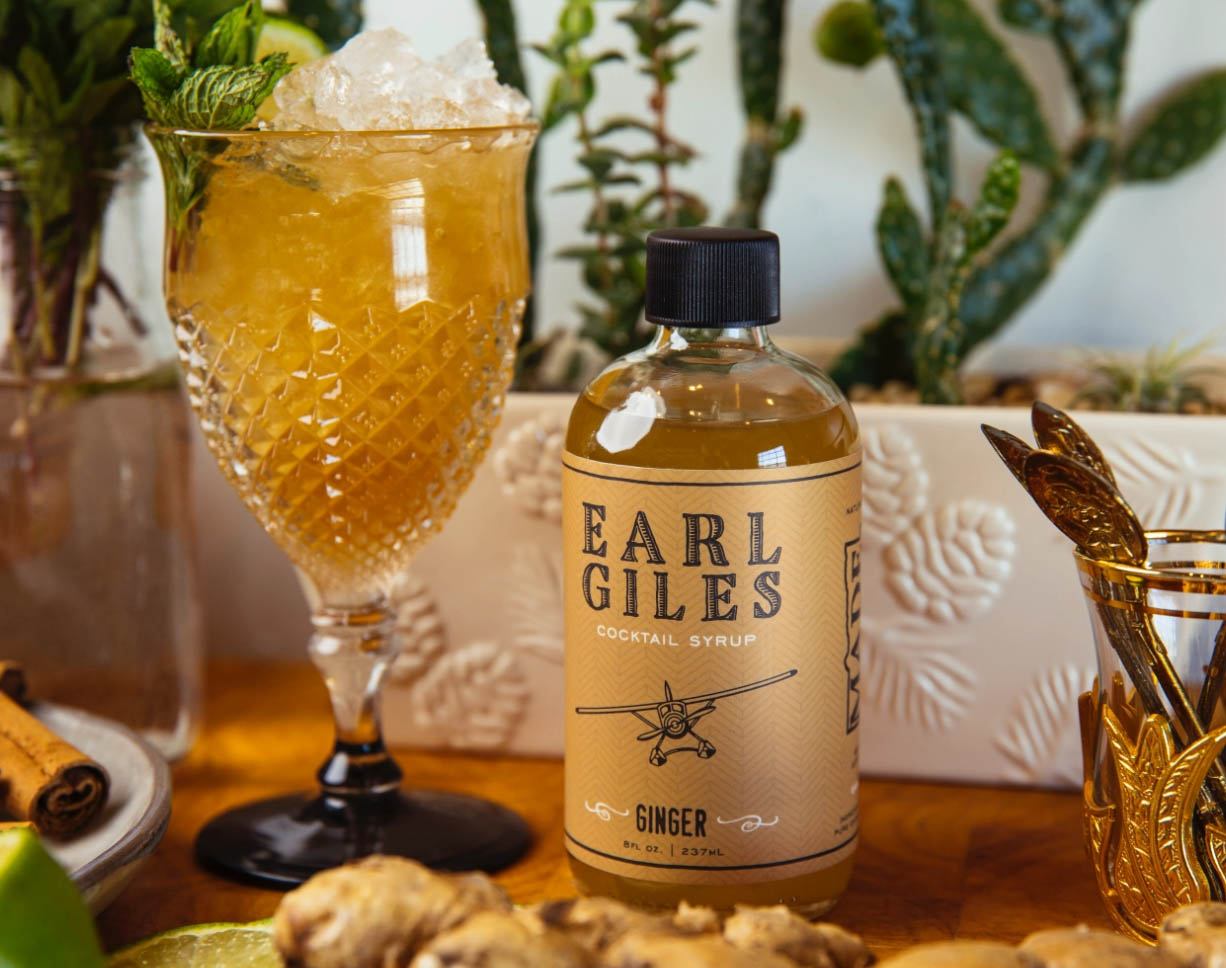 Earl Giles Ginger Cocktail Syrup on a table of food