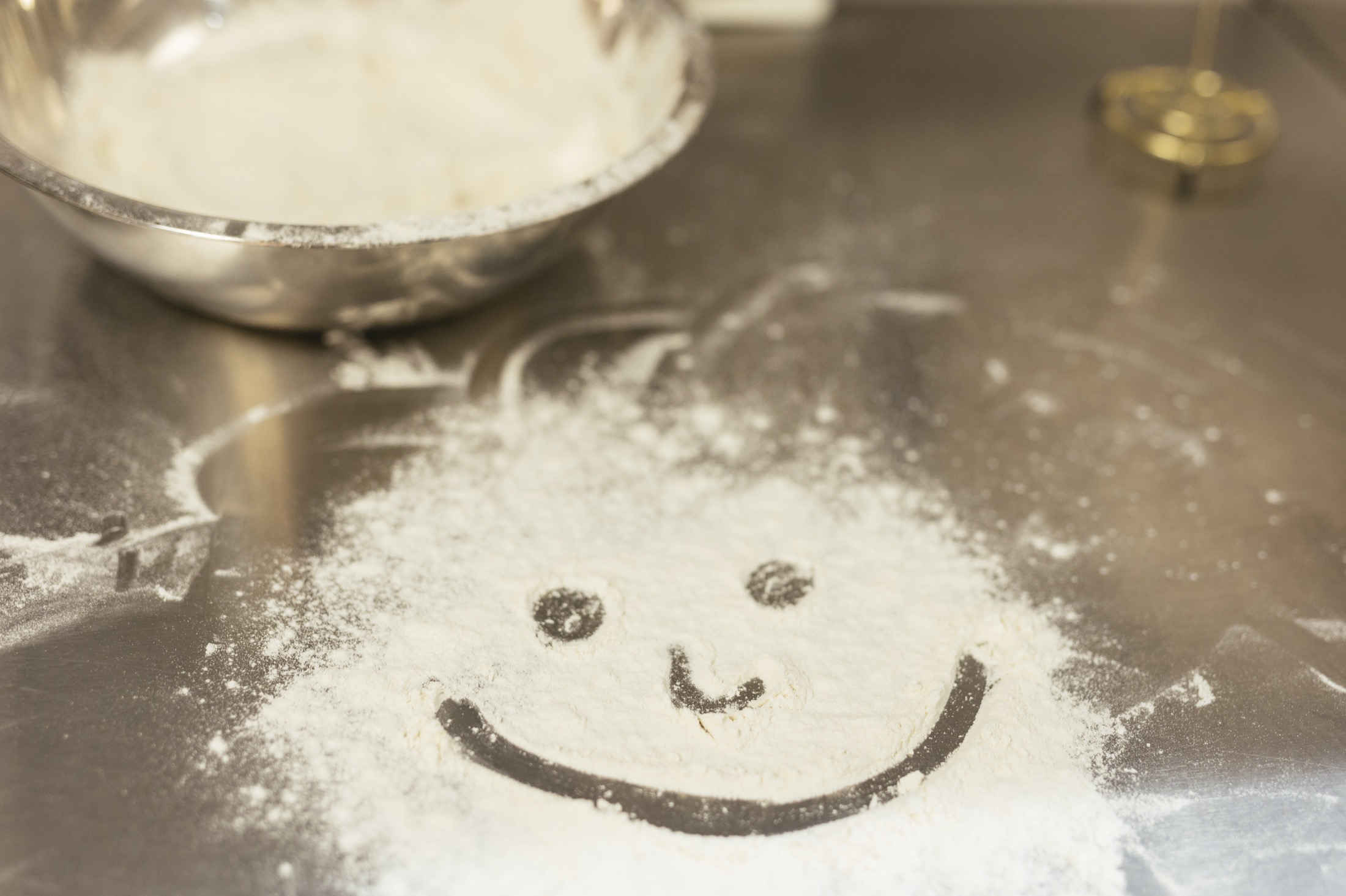 A smiley face drawn in cooking flour