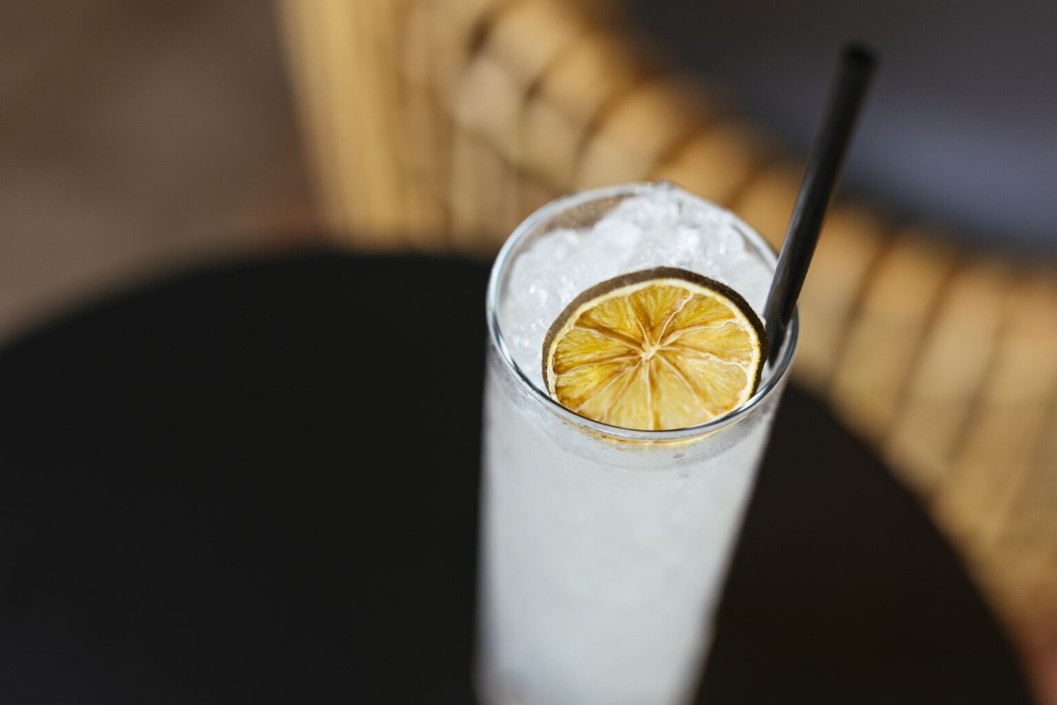 A tall white drink with a disco citrus slice on top
